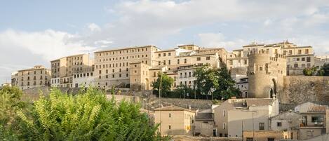 A historic town with medieval architecture, including a prominent tower and fortified walls.