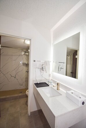 Separate tub and shower, rainfall showerhead, designer toiletries