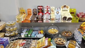 A variety of food items including cookies, pastries, and dairy products displayed on shelves and tables. - Nuovo Rondò (Sesto San Giovanni)