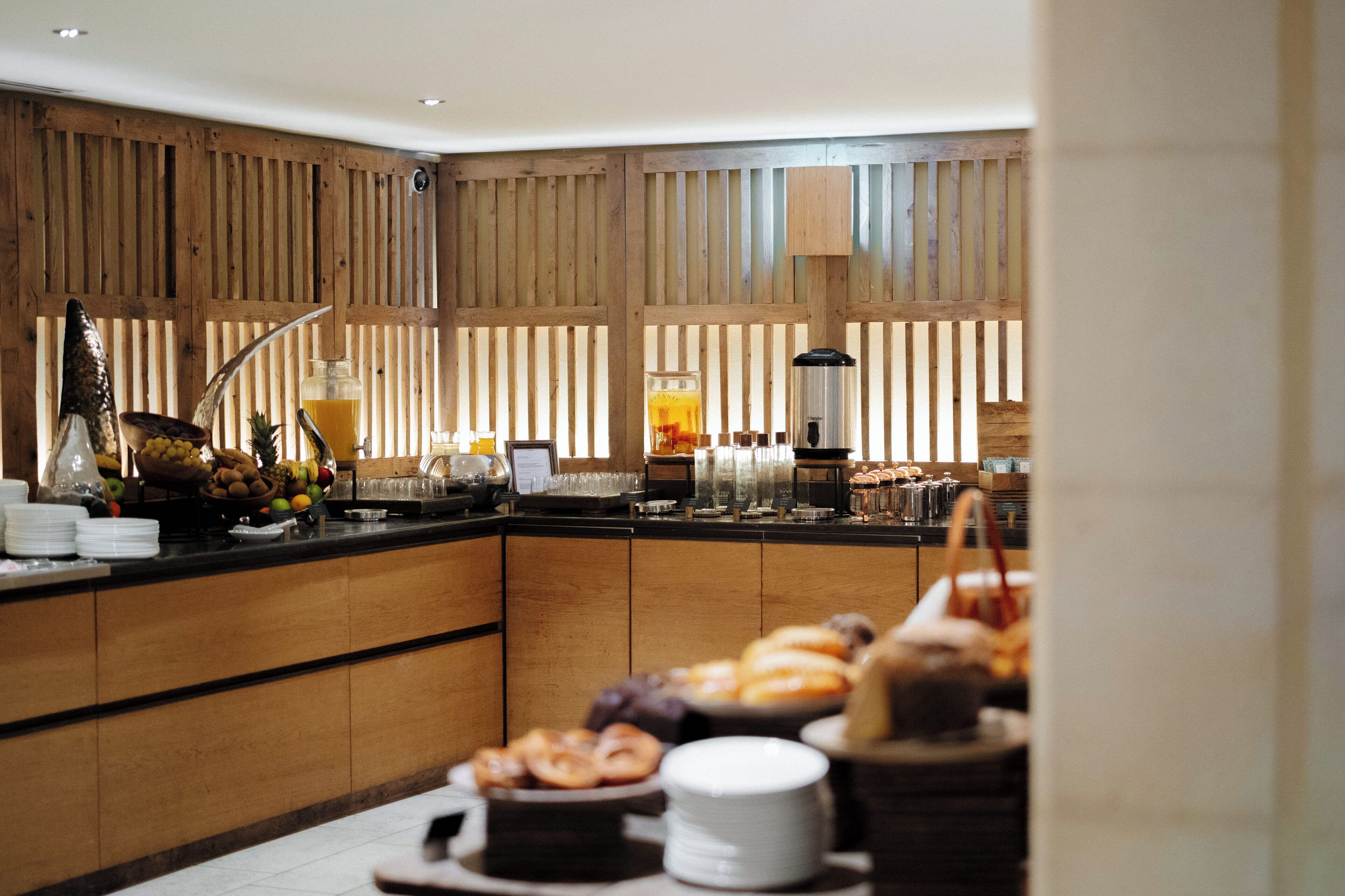 A breakfast buffet with various food items and beverages.