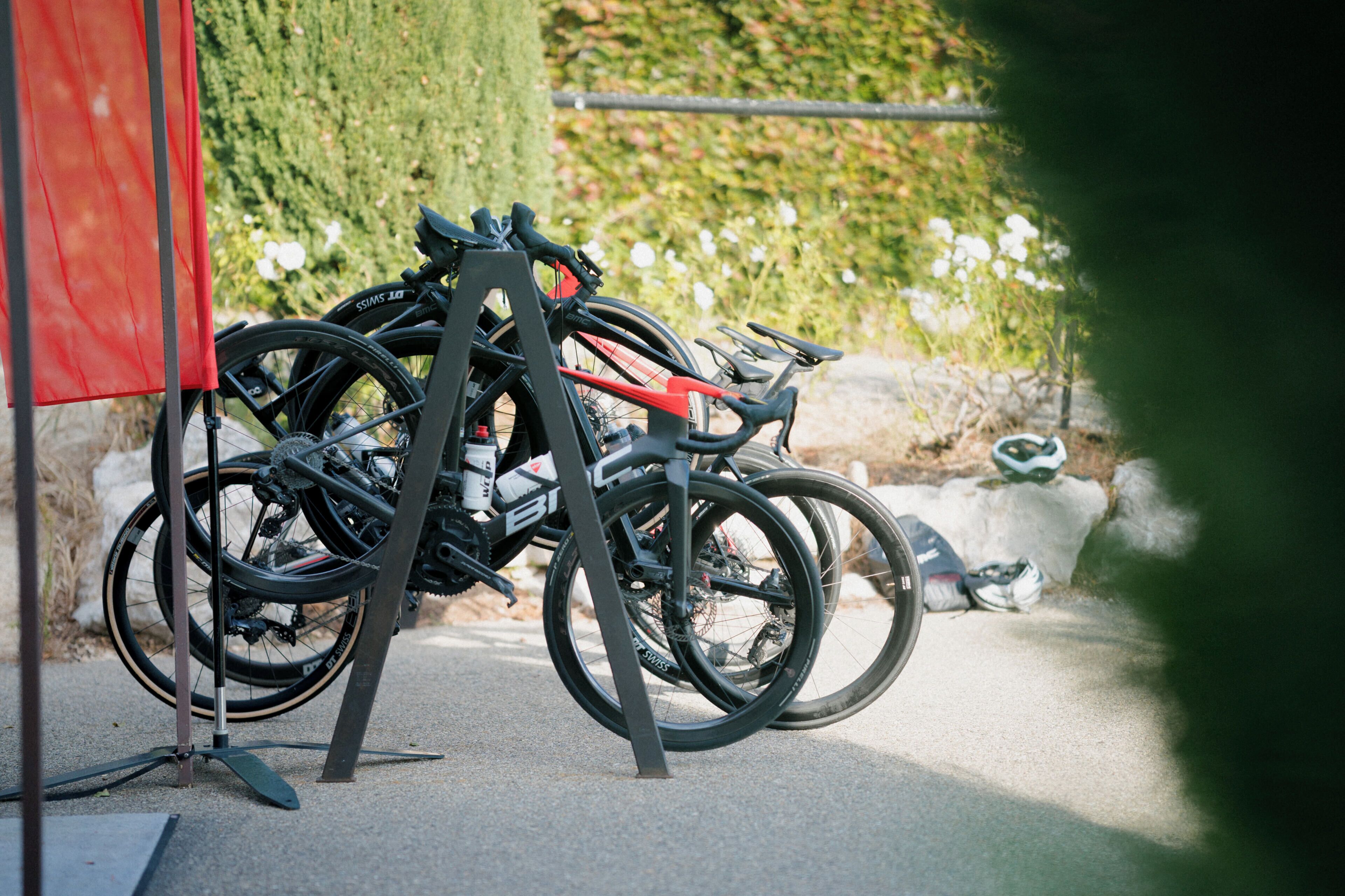 A bicycle rack with multiple bicycles parked.