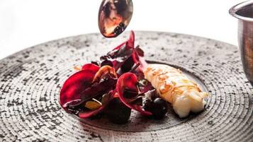 A plate with a piece of food and a spoon.