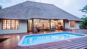 Outdoor pool, open 6 AM to 10 PM, pool loungers