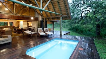 Outdoor pool, open 6 AM to 10 PM, pool loungers