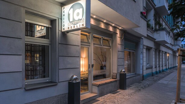 A modern building with a sign for '1a Pension Berlin' indicating it is an apartment building. - Pension 1A Apartment (Berlin)