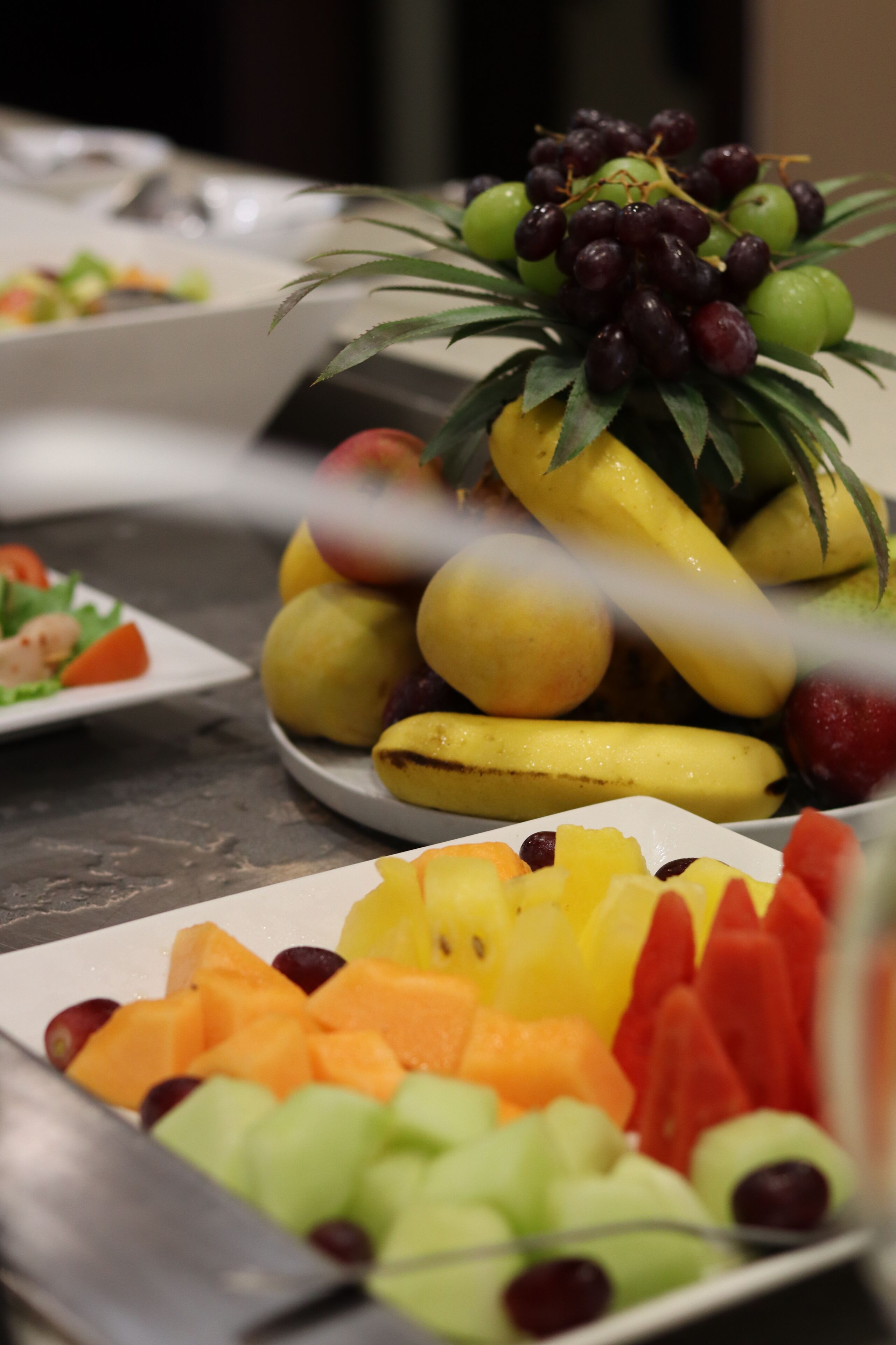 A buffet table with various fruits and vegetables.