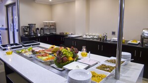 A buffet with various food items and beverages.