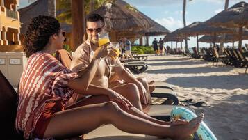 On the beach, white sand, sun loungers, beach umbrellas
