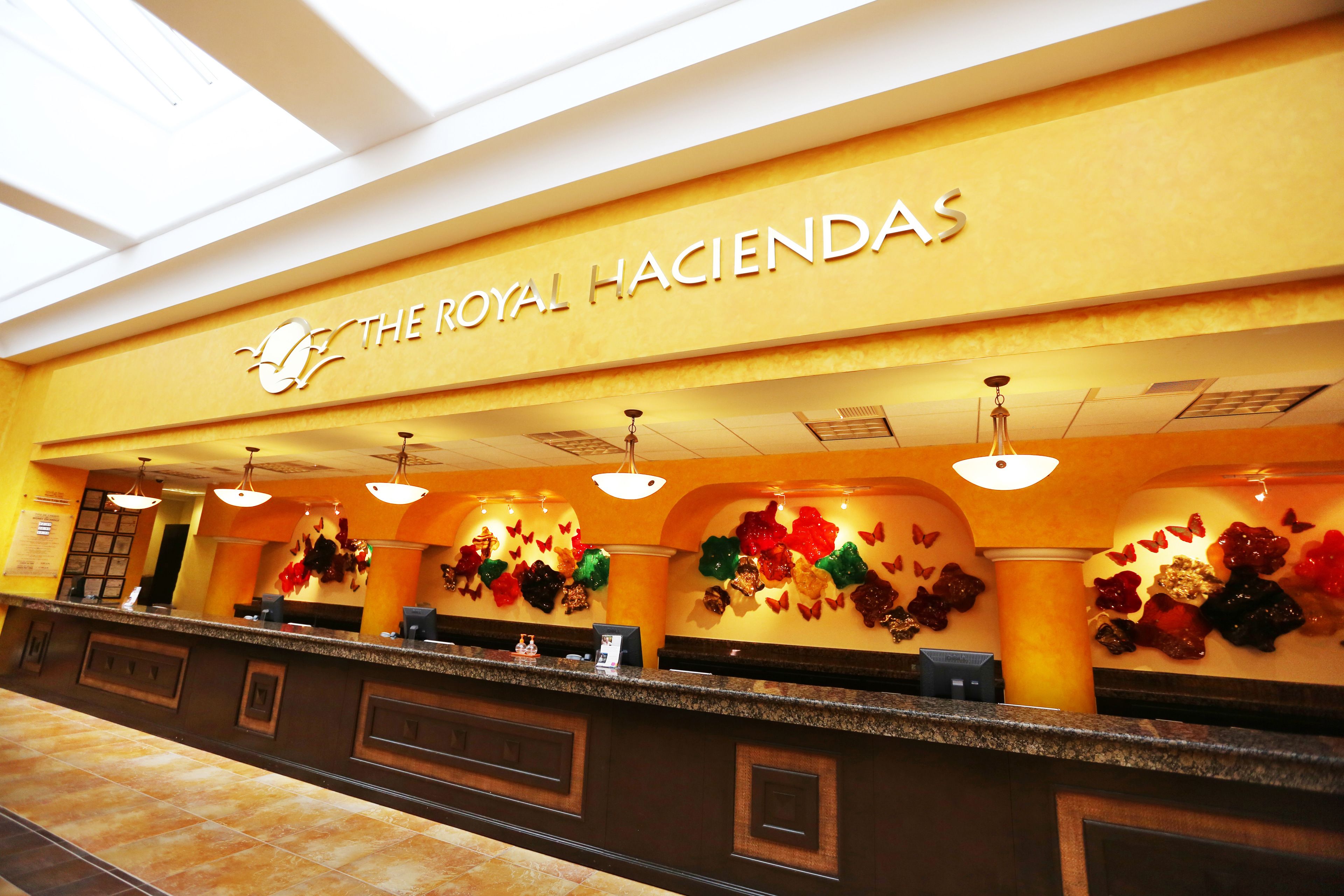 A reception area with a sign reading "The Royal Haciendas".