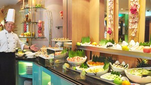 A buffet with various food items and a chef. - Makati Palace Hotel (Makati)