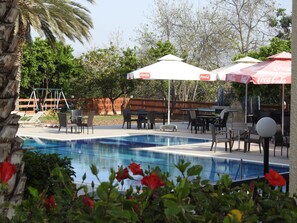 Seasonal outdoor pool, open 8:00 AM to 7:30 PM, pool umbrellas