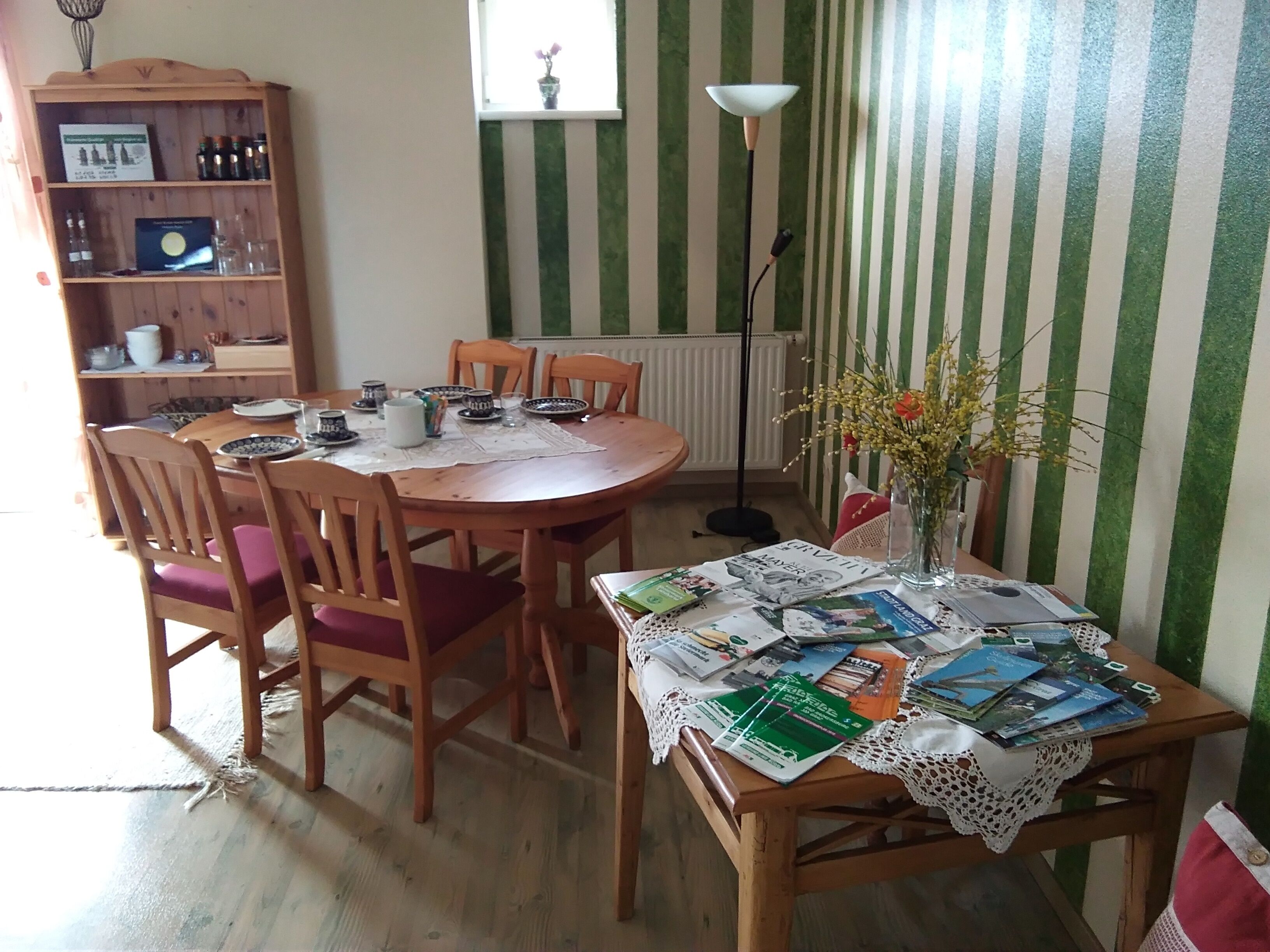 Comedor con una mesa de madera, sillas y una estantería.
