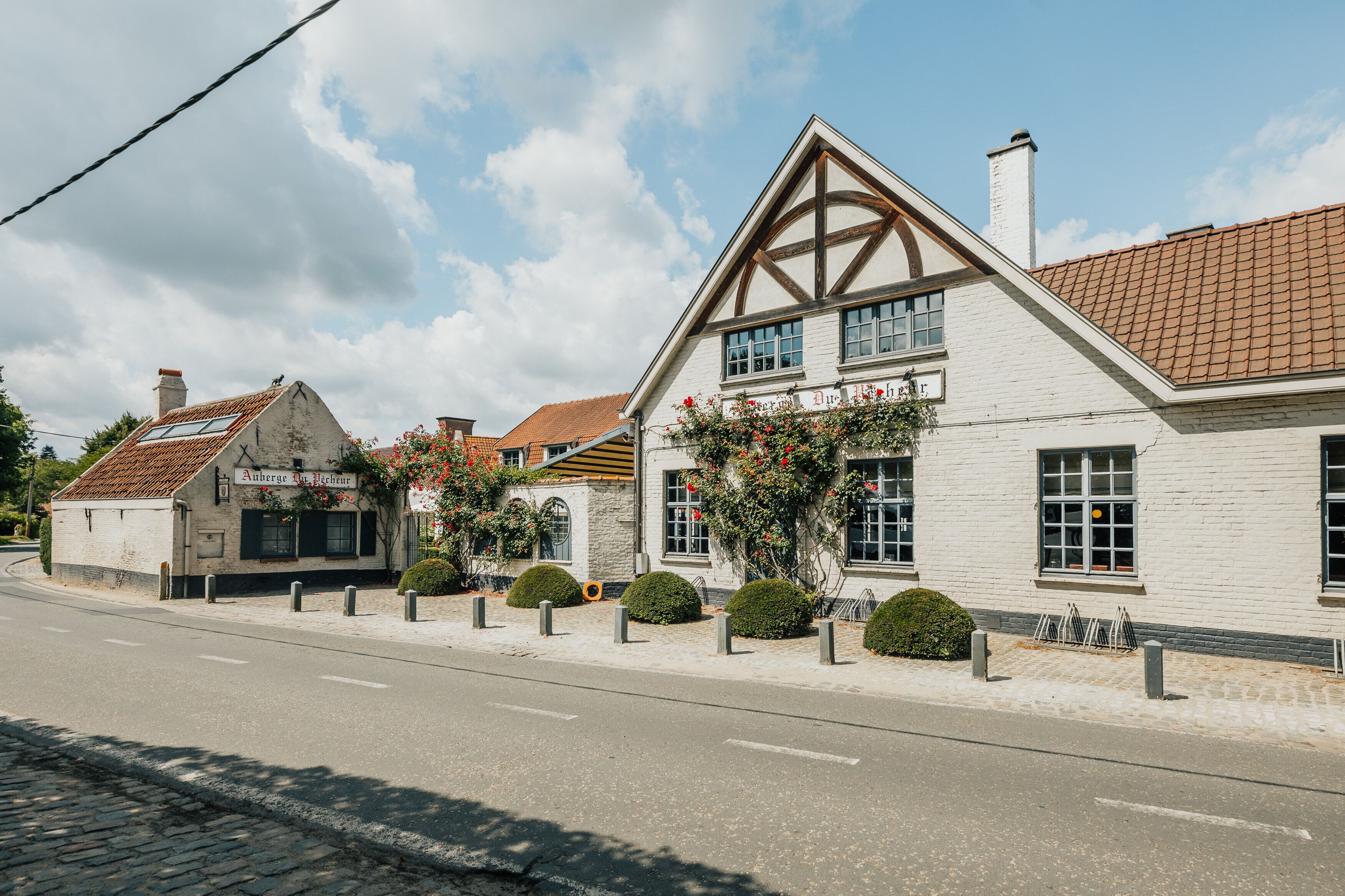 A traditional building with a stone facade, a pitched roof, and a sign indicating it is a restaurant.