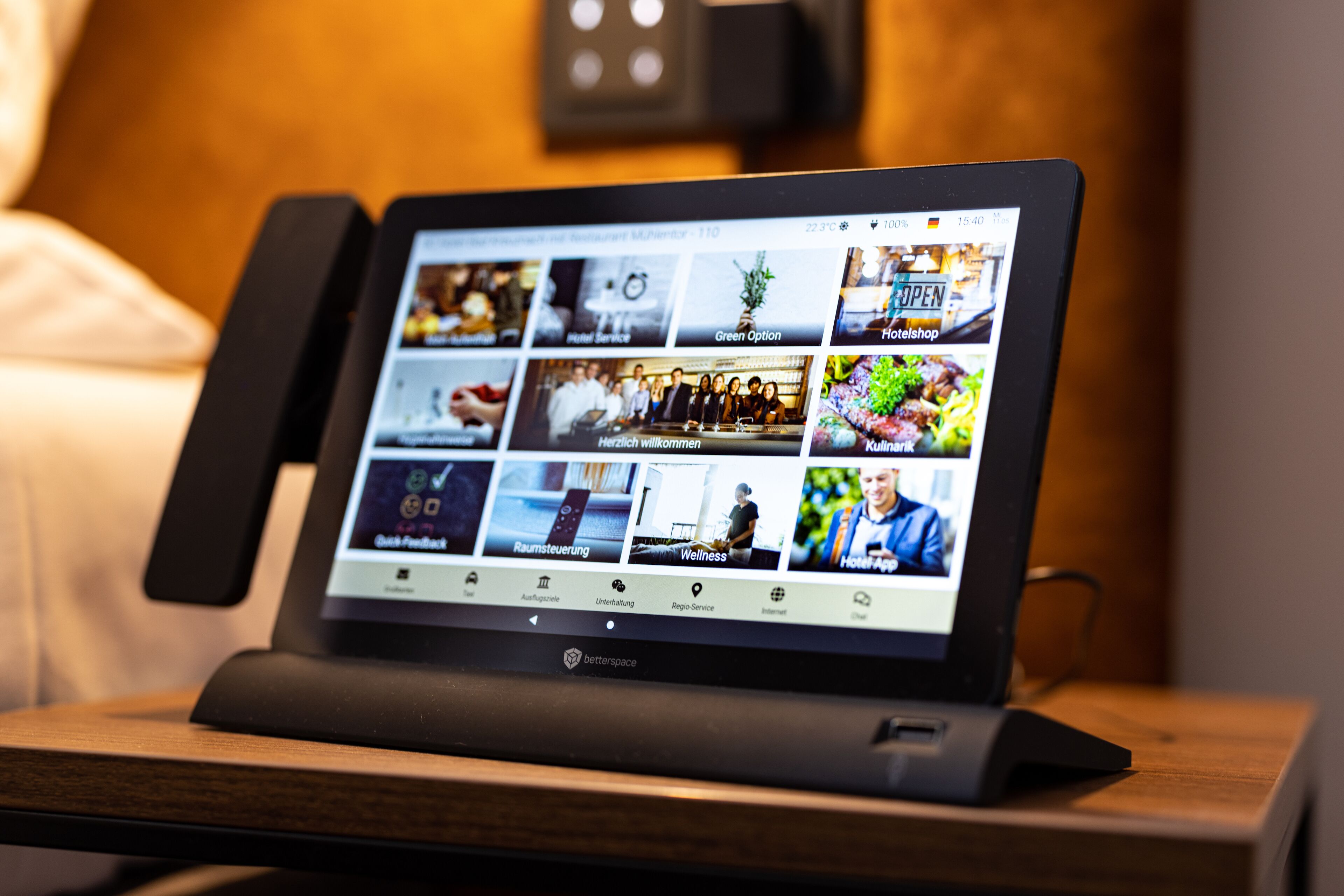 A tablet displaying various hotel services and amenities.