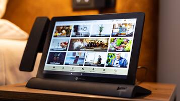 A tablet displaying various hotel services and amenities.