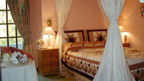 A bedroom with a bed, bedside table, lamp, and curtains. - The Old Inn (Gairloch)