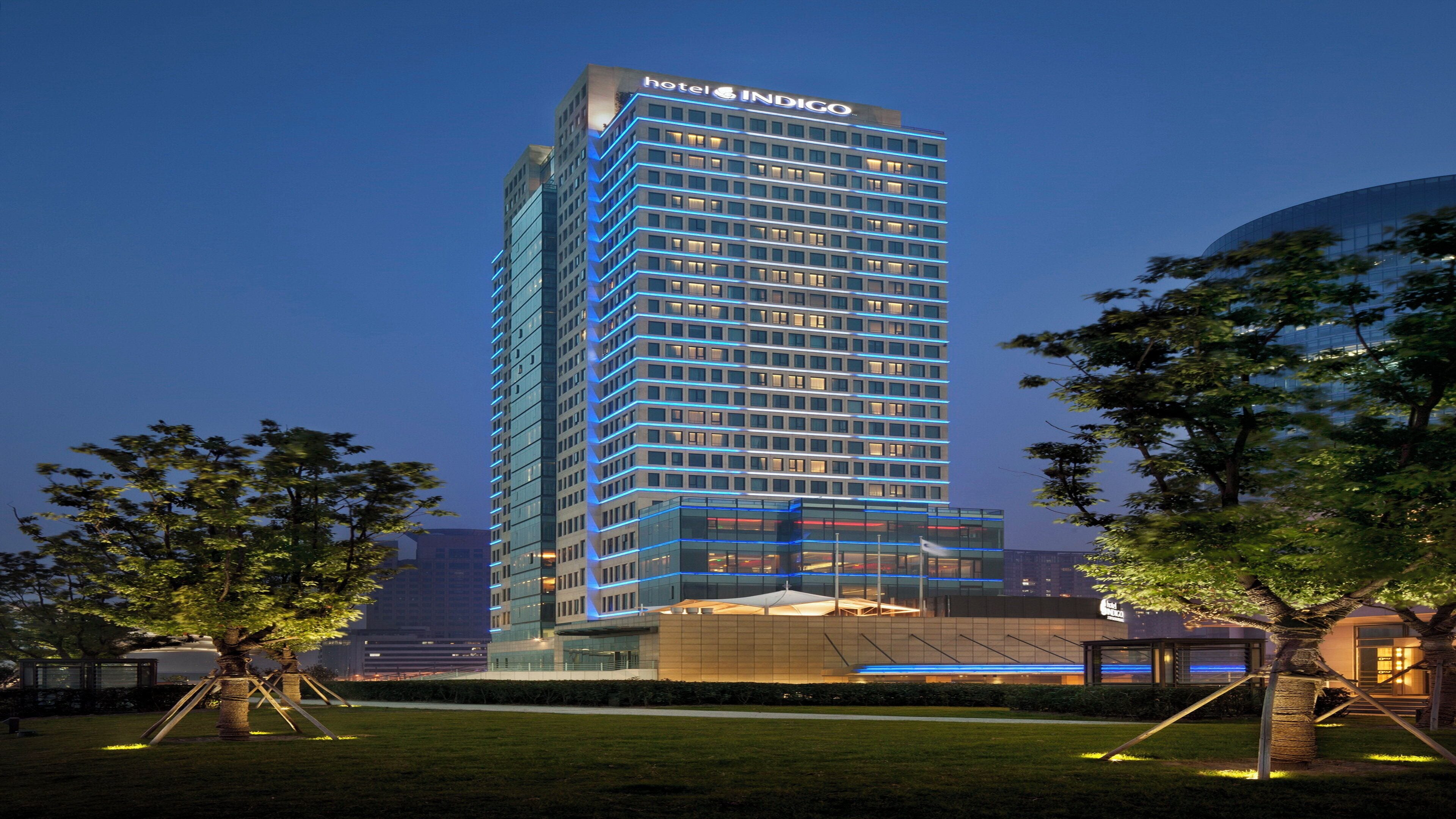 A modern hotel building with a prominent sign at the top.