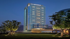 A modern hotel building with a prominent sign at the top.