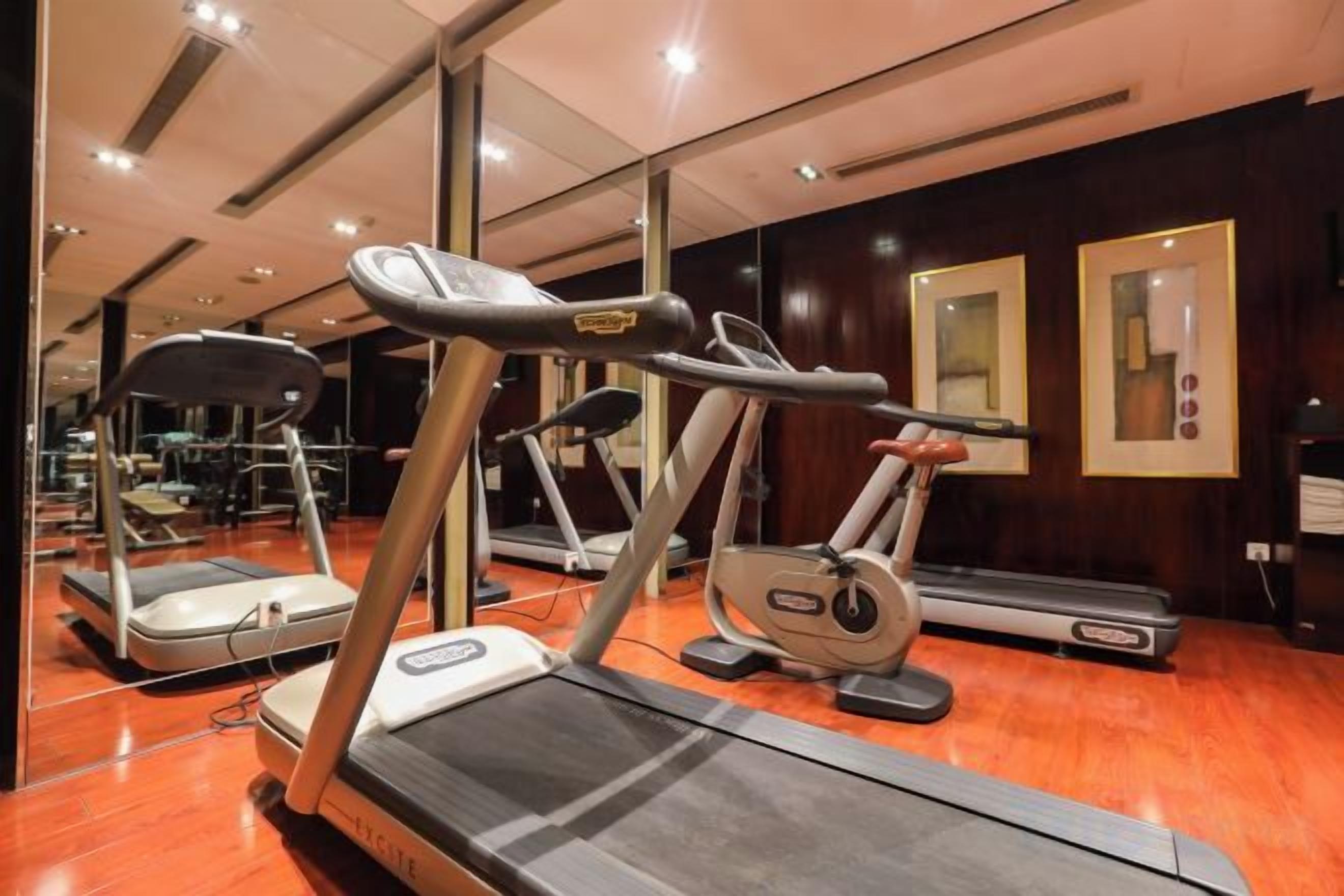 A gym with treadmills and elliptical machines.