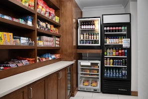 A snack and beverage vending area with various snacks and drinks. - Holiday Inn Express & Suites Alexandria - Fort Belvoir by IHG (Alexandria)