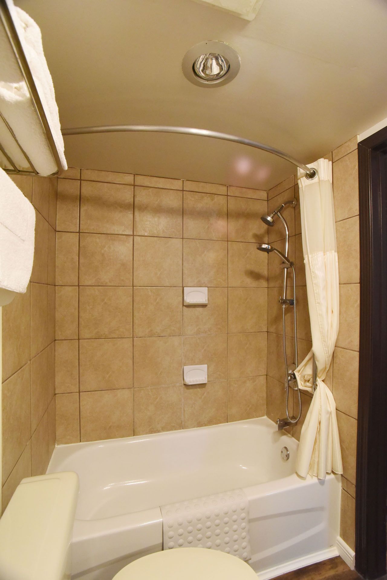A bathroom with a bathtub, a shower, and a toilet.