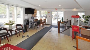 A hotel lobby with a reception desk, computers, and seating area. - Econo Lodge Inn & Suites Drumheller (Drumheller)