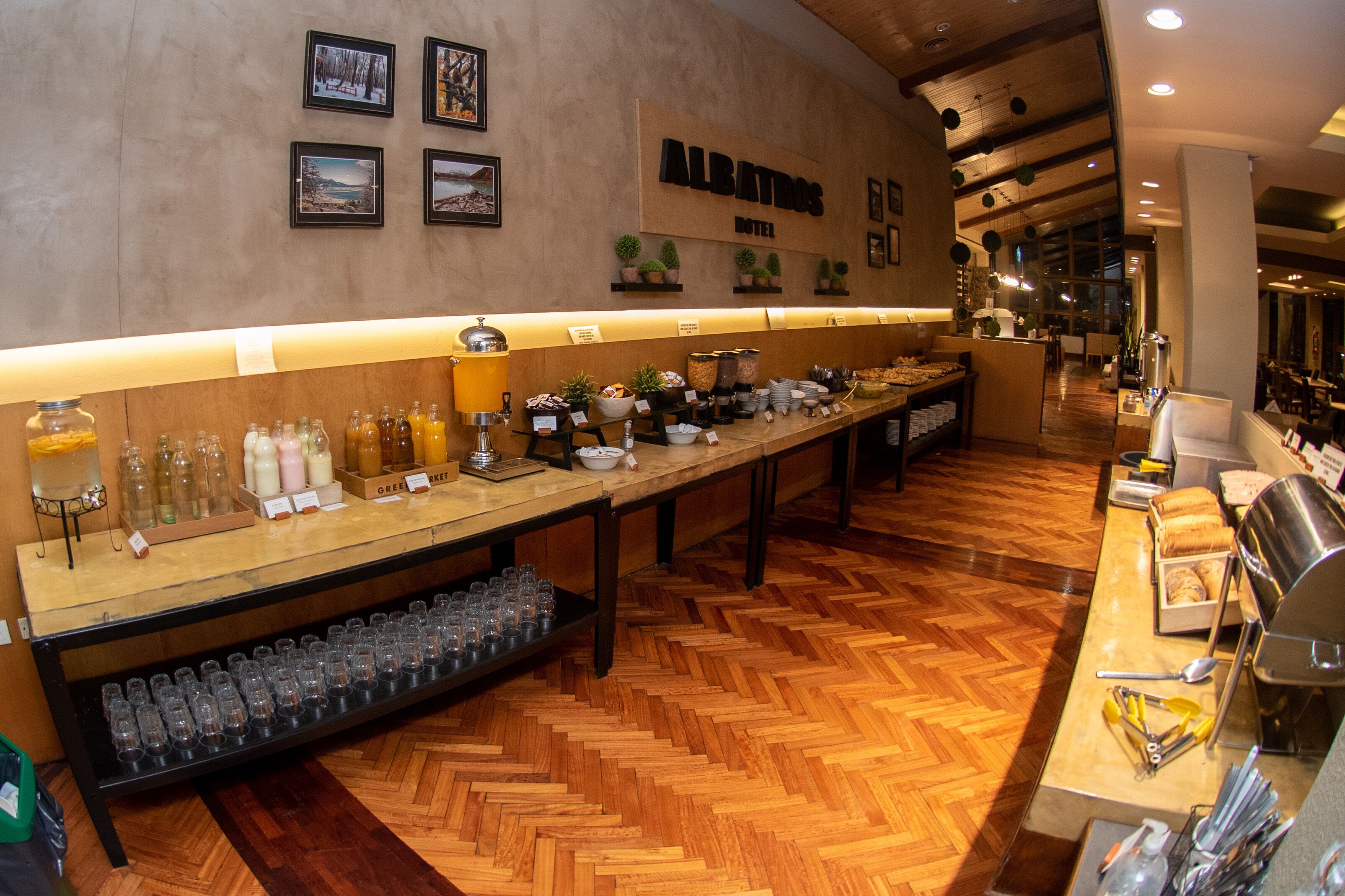 A hotel buffet area with a long counter displaying various food and drink options.