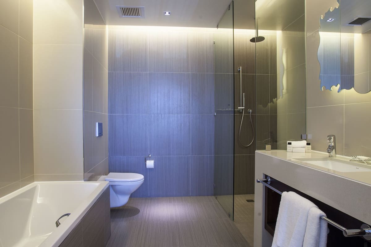 separate bathtub and shower, rainfall showerhead, designer toiletries