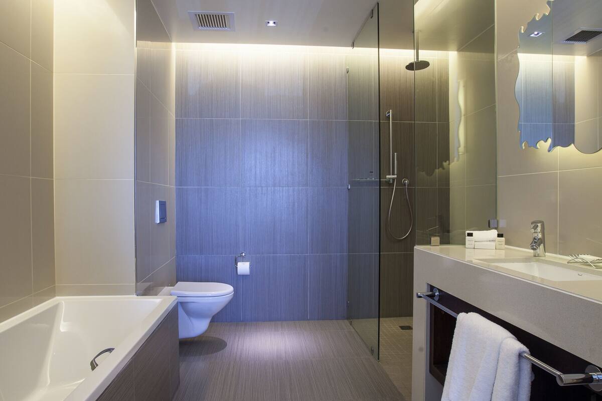 Separate bathtub and shower, rainfall showerhead, designer toiletries