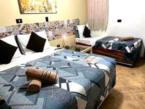 Economy-Dreibettzimmer, 1 Schlafzimmer, Erdgeschoss | Minibar, Zimmersafe, Verdunkelungsvorhänge, schallisolierte Zimmer