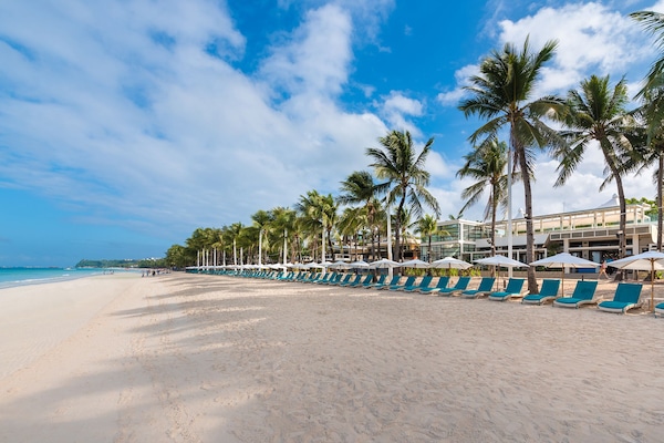 On the beach, white sand, beach umbrellas, beach towels