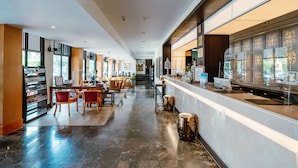 A spacious lobby with a reception desk, seating area, and a view of the outdoors. - Sawaddi Patong Resort & Spa by Tolani (Patong)