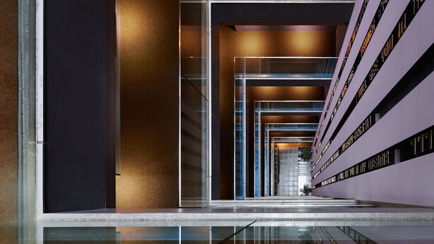 A modern building with a glass facade, a central staircase, and a series of balconies. - Akasaka Granbell Hotel (Tokyo)