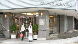 The entrance of the Riverge Akebono hotel with a modern design, featuring a glass facade and a signboard. - Hotel Riverge Akebono (Fukui)