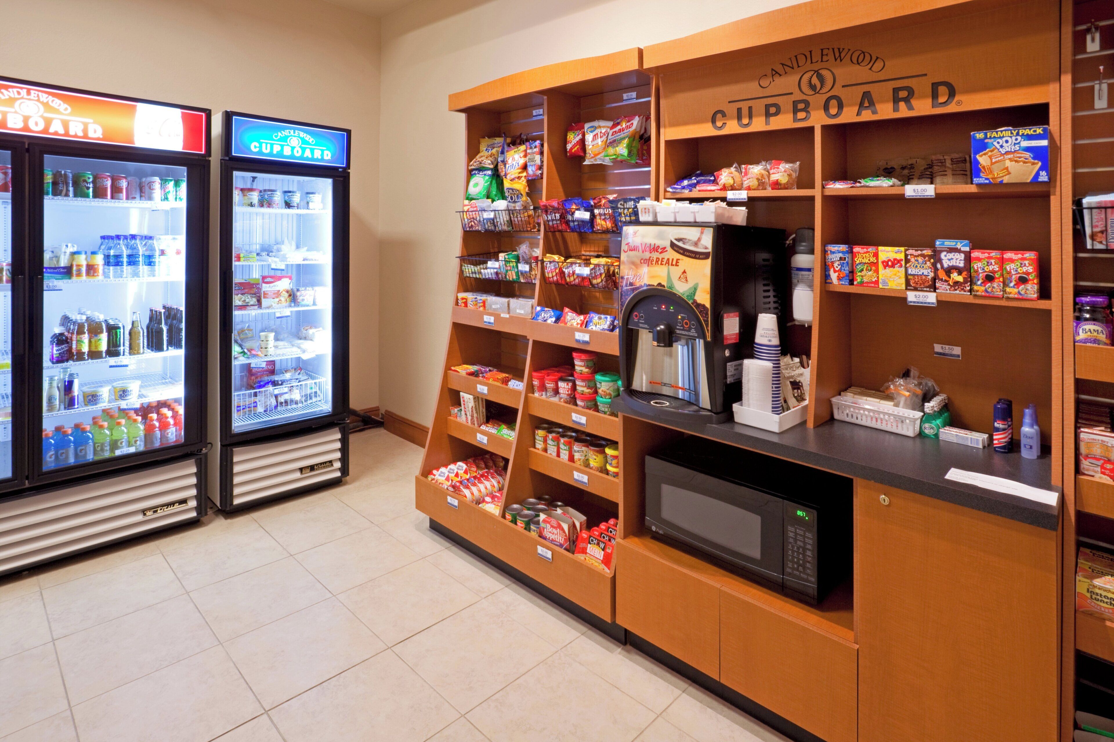 A self-service beverage station with refrigerated drinks and a coffee machine.