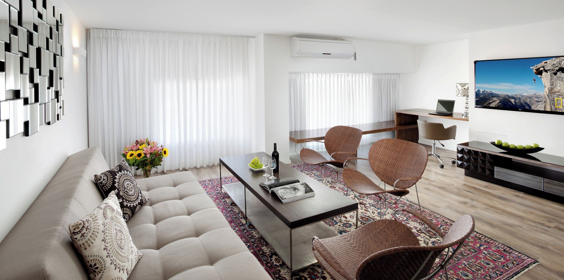 business apartment, private entrance (with staircase), 1 bedroom, jet tub, city view | living area | 50-inch flat-screen tv with satellite channels, books