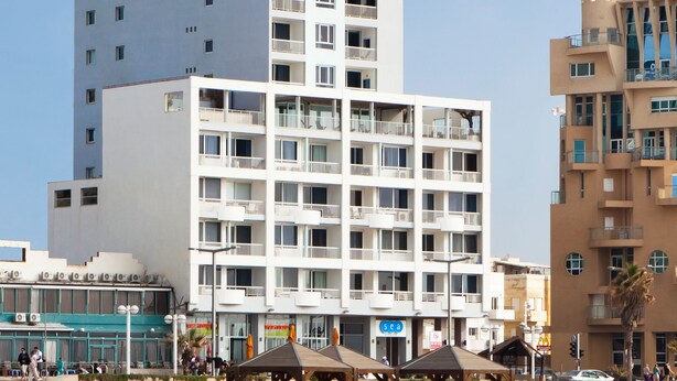 A modern hotel with multiple floors, balconies, and a beachside location. - Sea Executive Suites (Tel Aviv)