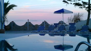 Seasonal outdoor pool, open 9:00 AM to 9:00 PM, pool umbrellas