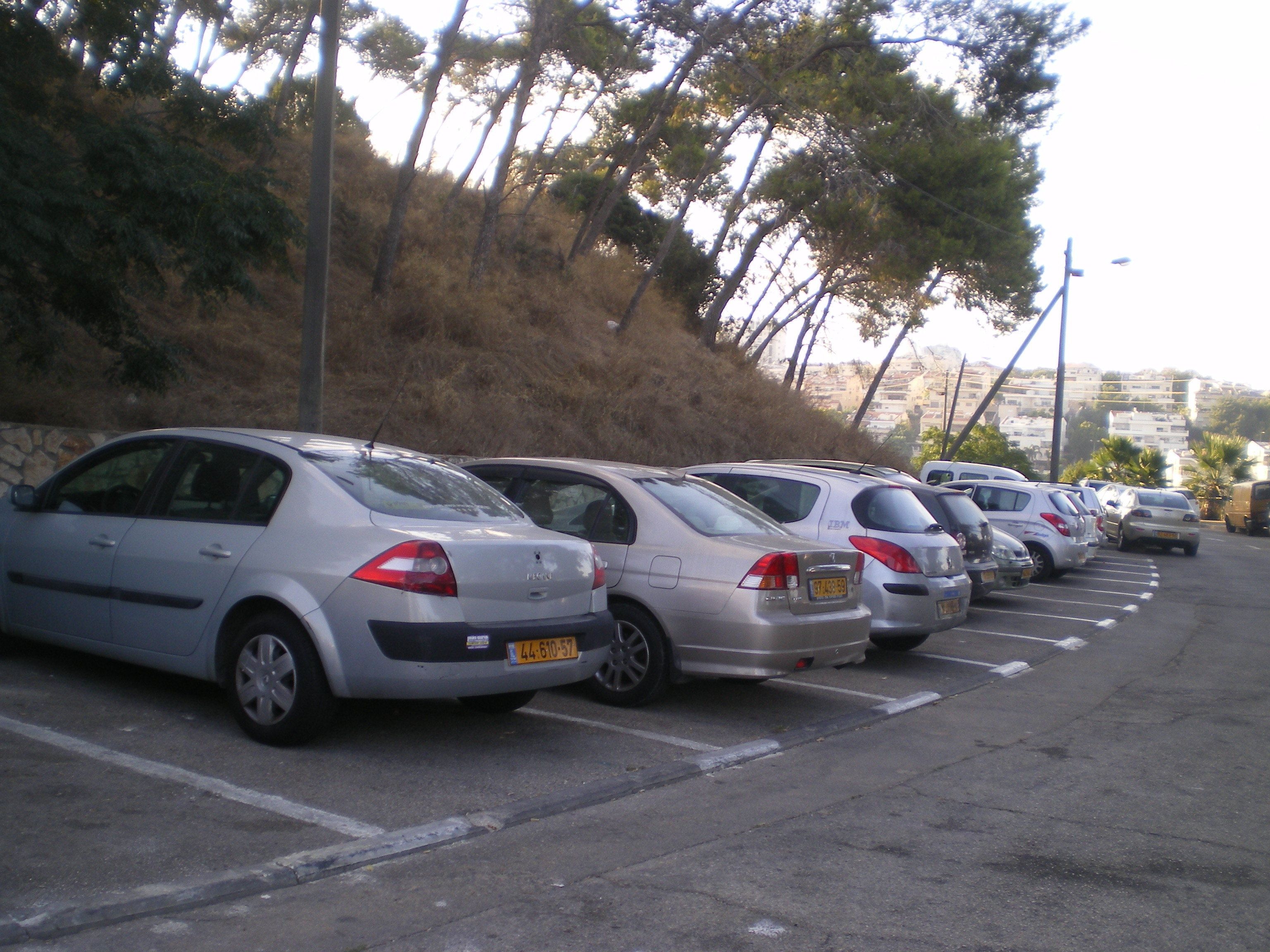 Un estacionamiento con varios coches aparcados.