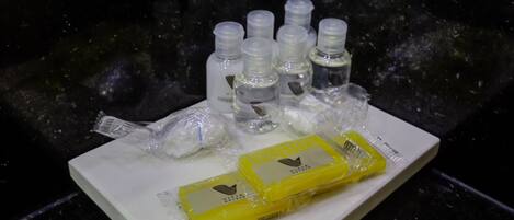 Una bandeja con varias botellas pequeñas y dos barras amarillas sobre una superficie blanca.