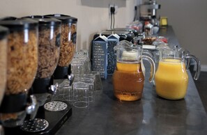 A beverage station with multiple dispensers, including a coffee machine and a pitcher of orange juice. - Bannview Bed & Breakfast (Craigavon)