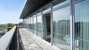 A modern building with large glass windows and a balcony with a metal railing. - Bannview Bed & Breakfast (Craigavon)