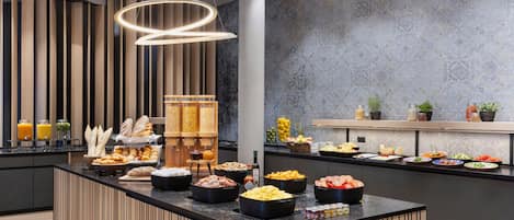 A buffet with various food items and a modern interior design.