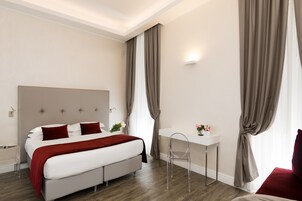 A modern bedroom with a bed, bedside table, chair, and curtains.