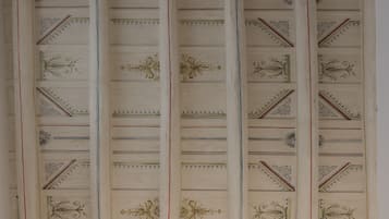 A ceiling with decorative panels and intricate designs.