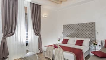 A modern hotel room with a large bed, a separate sofa, a small table, and a clear glass table.