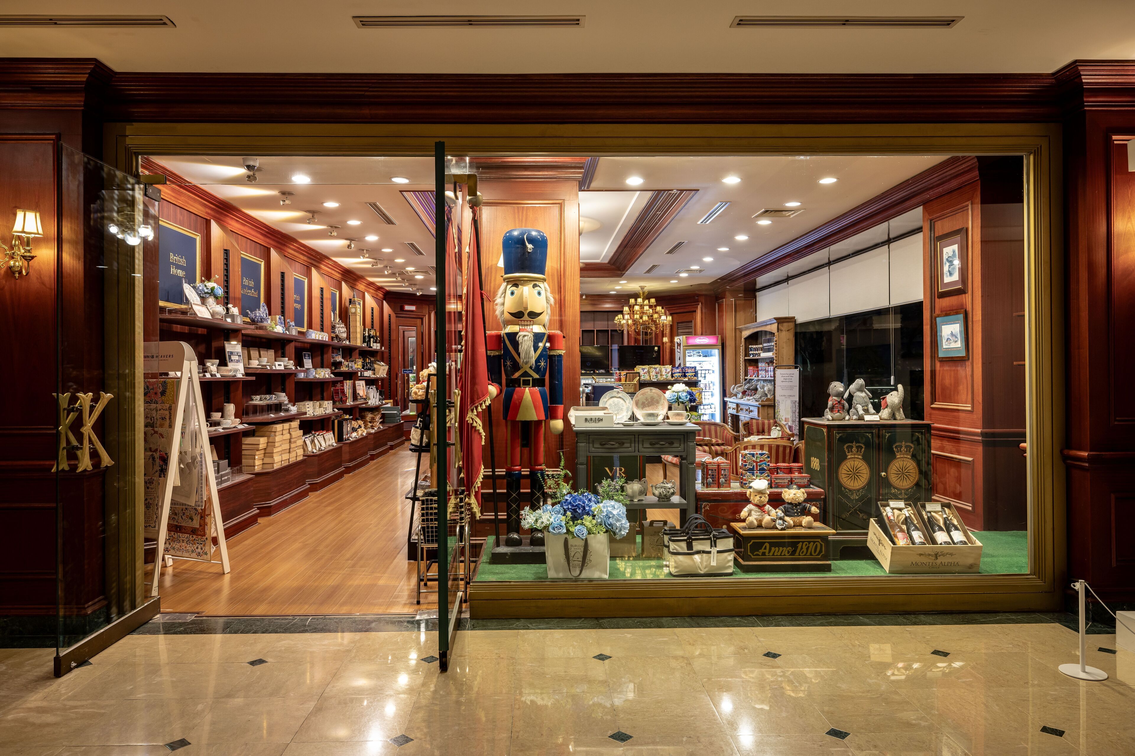 A luxury boutique hotel interior with wooden paneling, a central display of vintage items, and a well-lit, elegant ambiance.