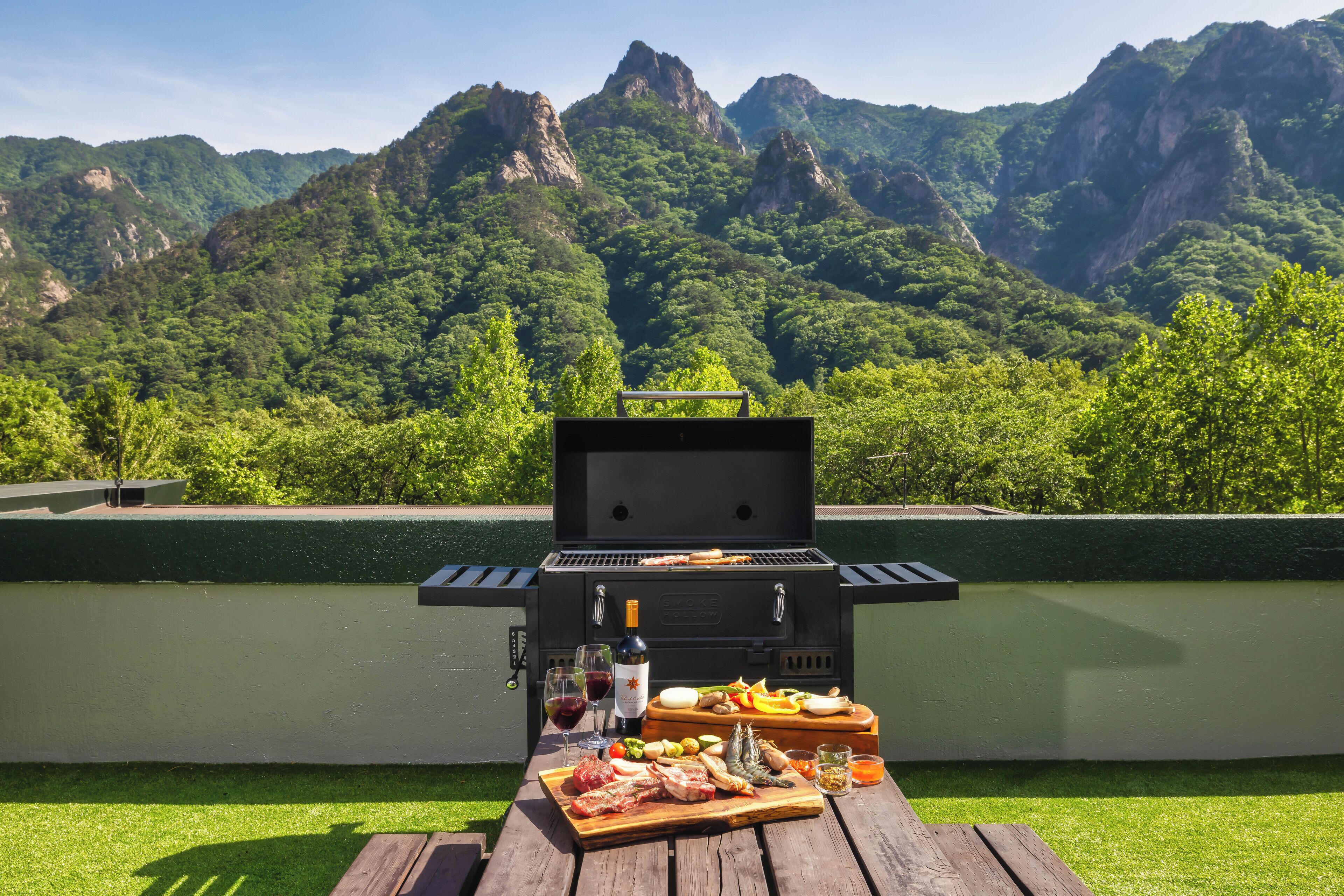 A barbecue setup with a view of mountains in the background.