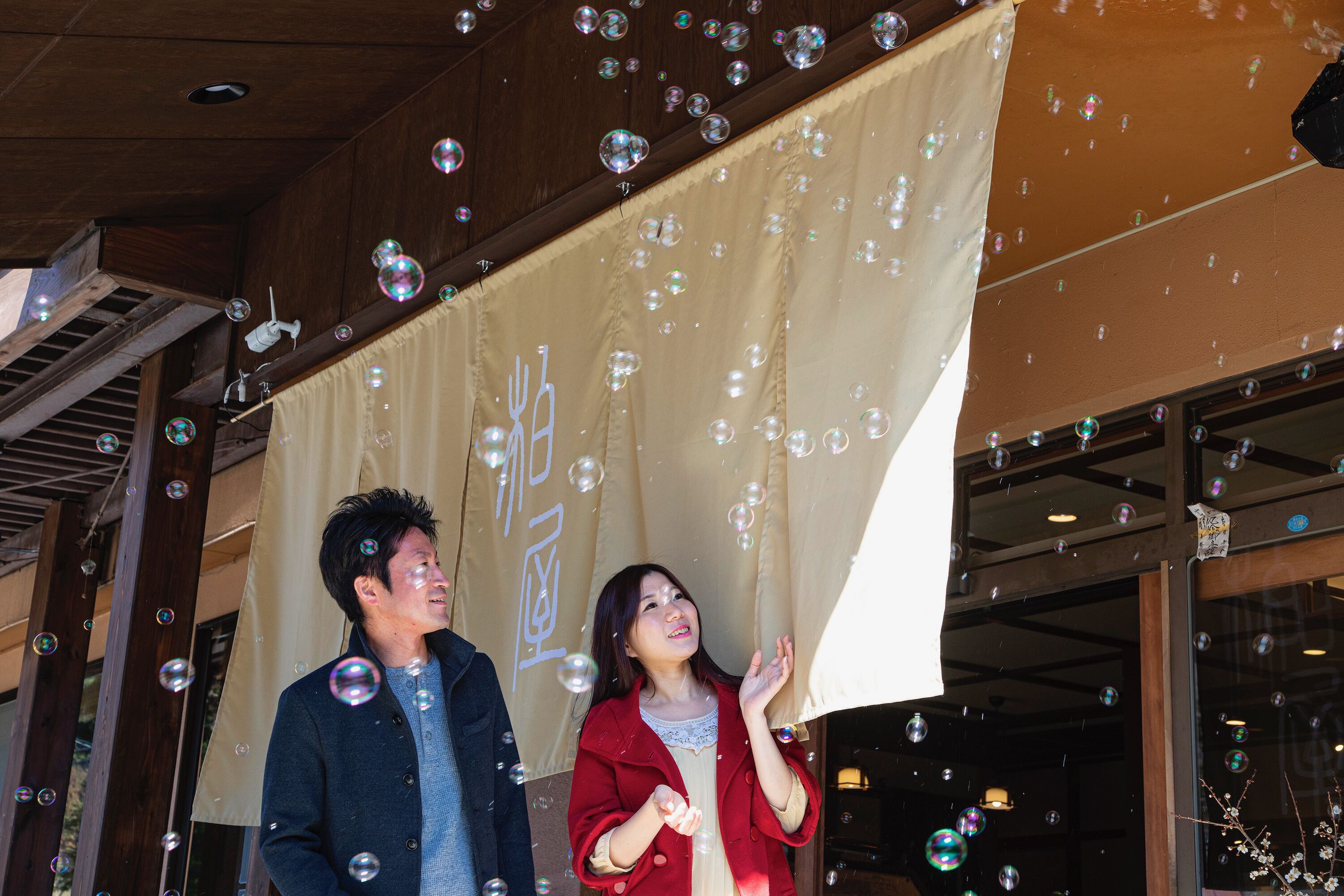 A building facade with a large banner and bubbles.