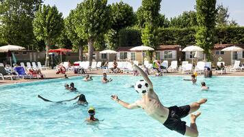 Relax by the pool surrounded by lush trees and enjoy a refreshing swim.